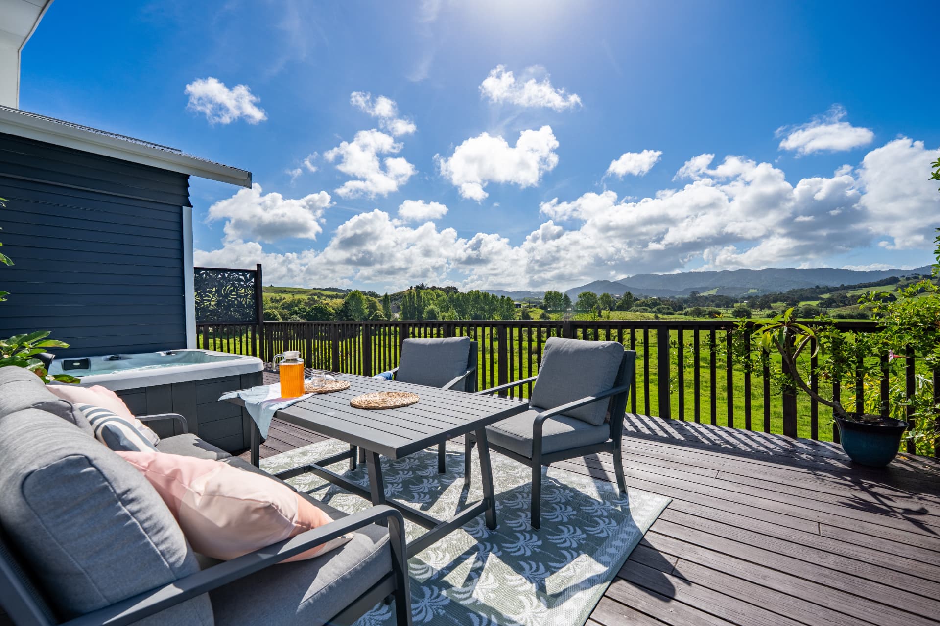 Outdoor deck with seating and rural views over Mangawhai countryside